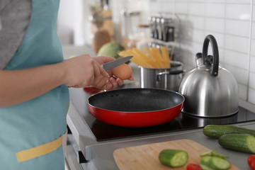 Young woman cooking in kitchen, closeup