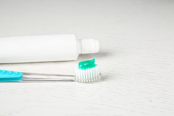 Manual toothbrush and paste on table. Dental care