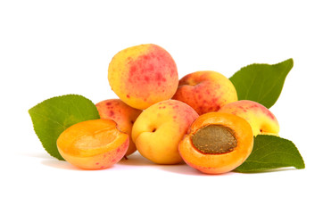 Several isolated apricots with a half. Lengthwise cut