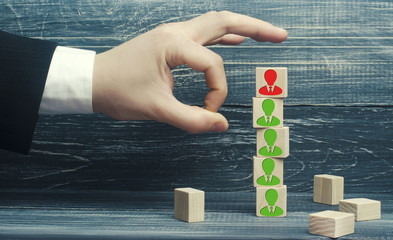 the businessman removes / dismisses the employee from the team. management within the team. wooden...