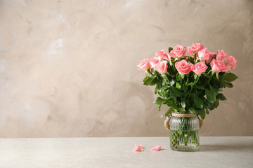 Vase with beautiful rose flowers on table