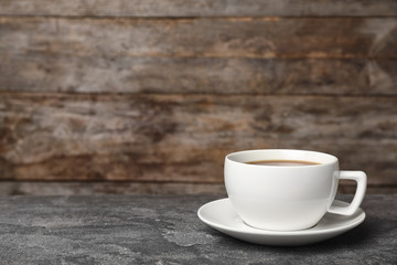 Obraz na płótnie Canvas White ceramic cup with hot aromatic coffee on table