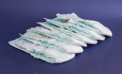 A stack of baby diapers on a blue background