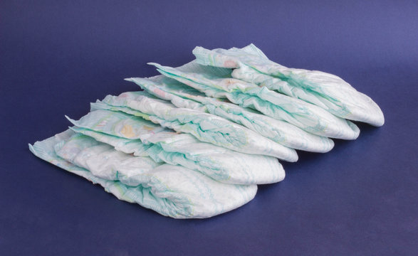 A stack of baby diapers on a blue background