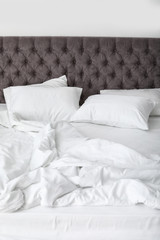 Fototapeta na wymiar Soft white pillows on comfortable bed, closeup