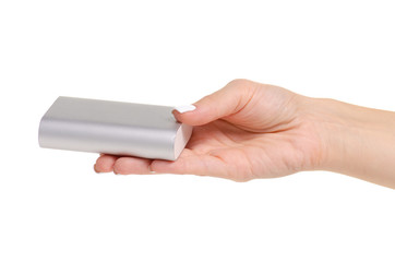 Gray power bank in hand on white background isolation