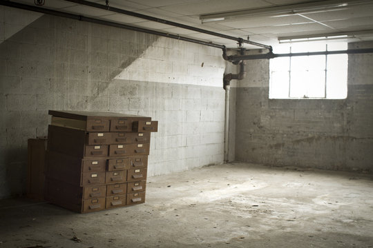 Antique Filing Cabinet Isolated In Dirty Room With Window
