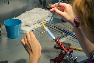 Master of glass in his work makes handmade ornaments.