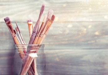 Row of artist paint brushes on background