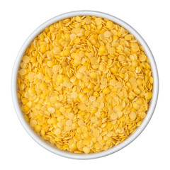 Beans of dry yellow split lentils in white bowl isolated on white background. Top view.