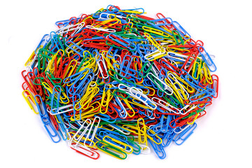 Pile of colored paper clips on isolated white background. Close up view.