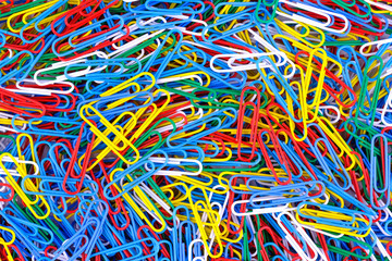 Many of colored paper clips background. Close up view.