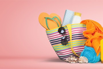 Beach bag, sunglasses  on a tropical beach