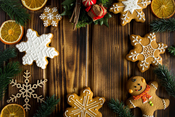Obraz na płótnie Canvas Christmas composition with gingerbread on the wooden background.Top view.