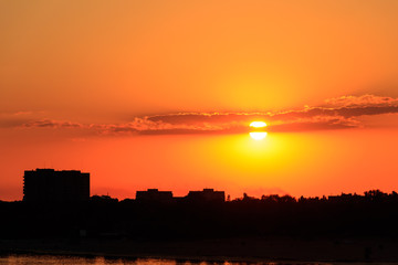 Obraz na płótnie Canvas Orange sunset over a river Dnieper in Kremenchug city, Ukraine