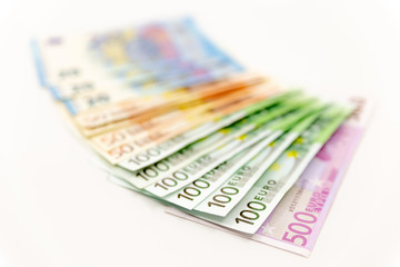 Spread Stack of Euro Banknotes, isolated close-up on white background