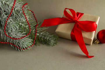 Christmas gift  with red ribbon on the  grey  background