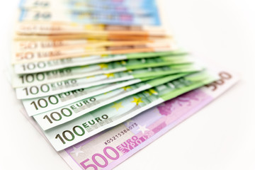 Spread Stack of Euro Banknotes, isolated close-up on white background
