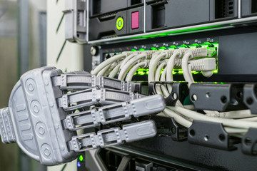 The robot works in the server room. A mechanical hand switch wires in the data center. A metal arm...