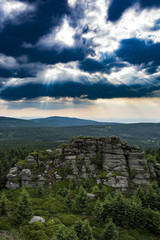 Obraz premium The rocky mountains landscape. View from the rock hill to landscape. Amazing and dramatic clouds and sky.