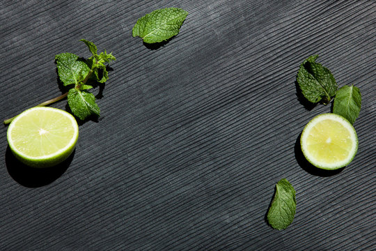 Food background, lime and mint on black