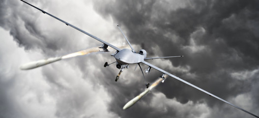 Drone strike .Front view of an unmanned aerial vehicle (UAV) military drone firing missile rockets at a target . 3d rendering
