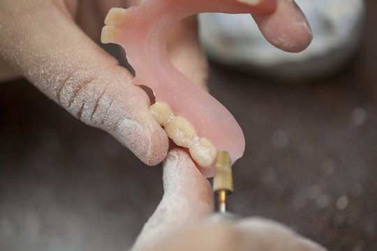 Dental technician make denture prothesis in dental laboratory