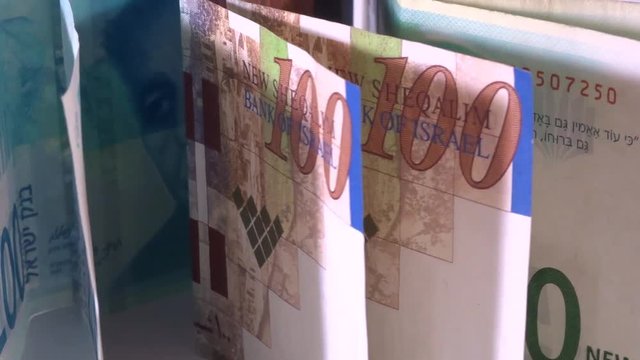 Israeli money, shekels bills in motion