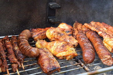 sausages, shish kebabs chicken and bacon baked on the grill