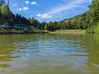blue sky reflection in lake water. cafe on riverside