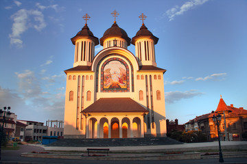 Fototapeta na wymiar Dramatic view at sunset of the new orthodox cathedral in the center of Drobeta Turnu Severin city, Romania - The Episcopal Cathedral 