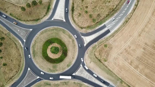 roundabout aerial top view zoom in, traffic circle with road circular intersection or junction