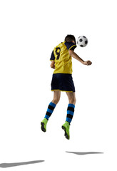 Young soccer player isolated on the white background with soccer ball and shadows