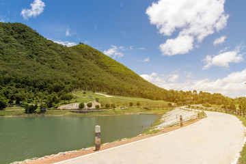 Fototapeta premium Scenery of mountain landscape with lake and sky,Beautiful the reservoir water and green mountain with blue sky and clouds beauty in Thailand