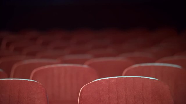 Empty movie theater auditorium with seats. Rows of void seats in cinema. Cinema theatre hall with empty armchairs. Cinema hall with red armchairs. Movie entertainment
