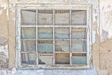 Old window in a ruined house, close-up