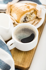 Morning coffee with croissant on the table