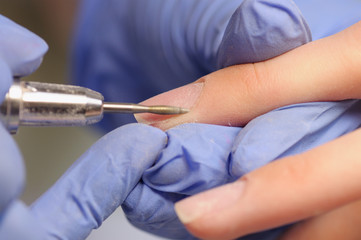 Professional manicure process in beauty salon.