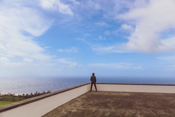 Person / Tourist / young girl in a scenic view outside of the Lady of Peace church (Nossa Senhora da Paz) in Azores, Portugal