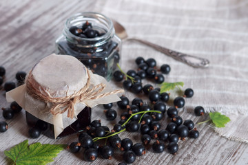 Jam or marmalade of black   currant berries on a light background