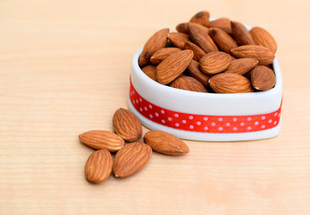 Almonds in ceramic bowl of heart shape
