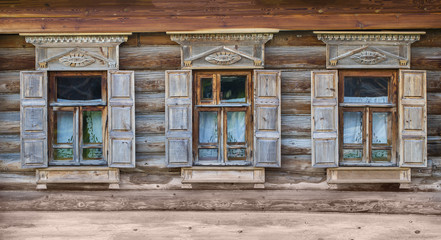 Fototapeta na wymiar Windows on the Facade of a Wooden House