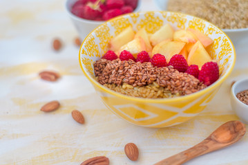 gorgeous healthy breakfast, oatmeal porridge with flax seeds, raspberries and nuts, concept healthy food