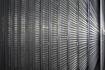 Stack of perforated steel plate sheets for processing in a metal working factory