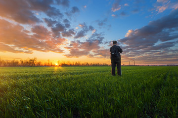 photographer on the field during sunset / hobby that brings pleasure