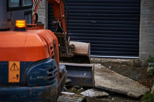 Digger ( partly out of focus ) at construction