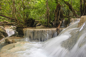 Long exposure of pure flowing water in tropical forest at Erawan National Park, in Kanchanaburi province, Thailand.