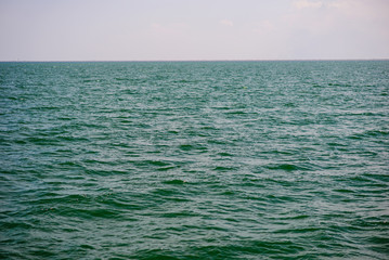 the blue ocean with dull clouds on a lovely sunny day