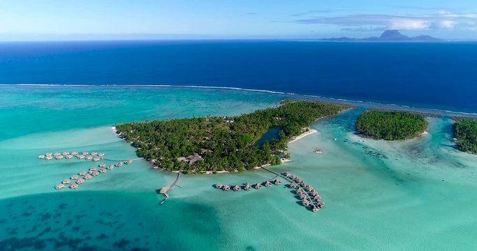 Water bungalows resort at islands, french polynesia in aerial view