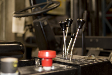 Used forklift wheel cockpit in an industrial company service levers gear lift up down red button...